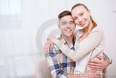 Young lovely couple sitting and hugging Stock Photo