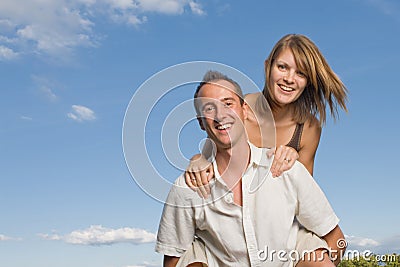 Young lovers piggy back Stock Photo