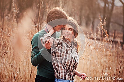 Young loving couple having fun on the walk in country field Stock Photo