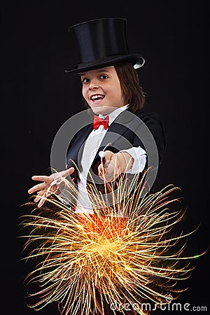Young magician boy using his magic wand Stock Photo