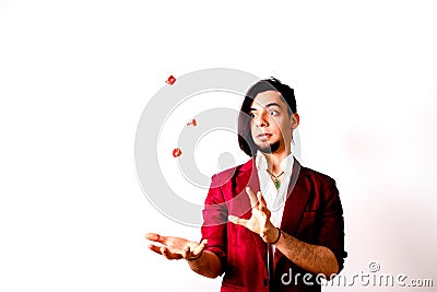 Young magician throwing dice to the air to look for luck Stock Photo