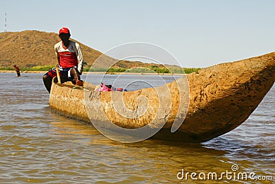 Young Malagasy rafter man rowing traditional canoe Editorial Stock Photo