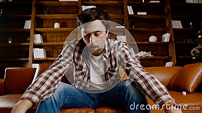 Young male alcoholic requires medical and psychological help. Man addicted alcohol and cannot stay on couch at home on Christmas Stock Photo