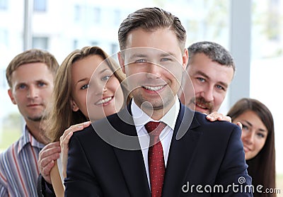 Young male business leader standing in front of his team Stock Photo