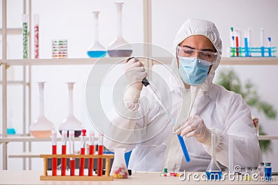 Young male chemist in drugs syntesis concept Stock Photo