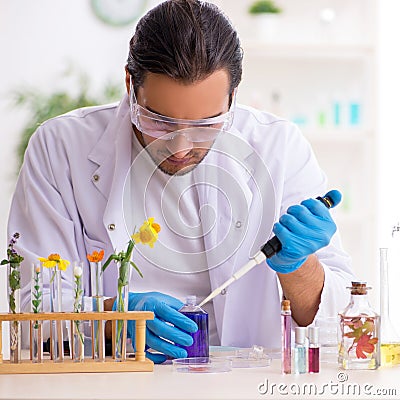 Young male chemist in perfume synthesis concept Stock Photo