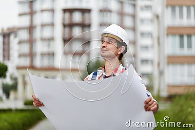 Young architect in front of apartment building Stock Photo