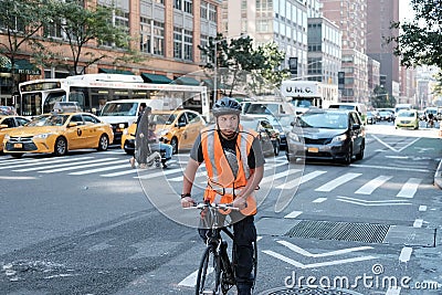 Young male cyclist seen wearing a high vis jacket and bike helmet. Editorial Stock Photo