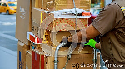 Young male deliverer with boxes outdoors Editorial Stock Photo