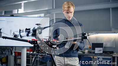 Young Male Developer Programming on Laptop Computer. Working on a New Drone Design in the Research Stock Photo
