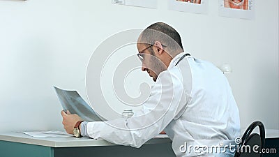 Young male doctor examining chest xray image Stock Photo
