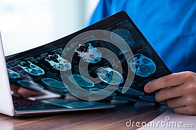 Young male doctor looking at x-ray images Stock Photo