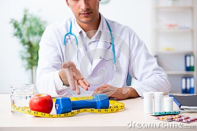 Young male doctor in sport and dieting concept Stock Photo