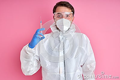 Young male doctor in white coat with syringe, medicine concept Stock Photo