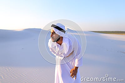 Young male emirate suffers from severe pains in abdomen, standin Stock Photo