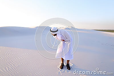 Young male emirate suffers from severe pains in abdomen, standin Stock Photo