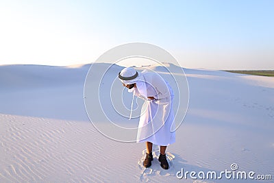 Young male emirate suffers from severe pains in abdomen, standin Stock Photo