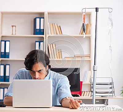 Young male employee in blood transfusion concept Stock Photo