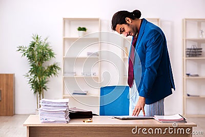 Young male employee in oversleeping concept Stock Photo