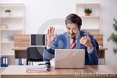 Young male employee with star award at workplace Stock Photo