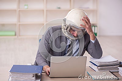 Young male employee wearing spacesuit in the office Stock Photo