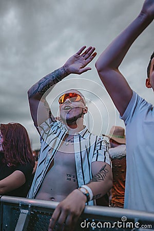 Young male happily singing during electronic music festival Electrifinity in Bad Aibling,Germany Editorial Stock Photo