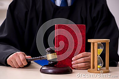 Young male judge in time management concept Stock Photo