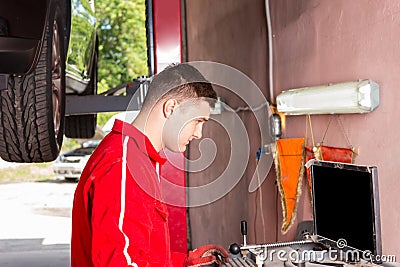 Young male mechanic checking the readout Stock Photo