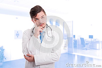 Young male medic thinking while looking at distance Stock Photo