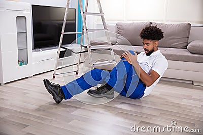 Male Mover Falling From Ladder Stock Photo