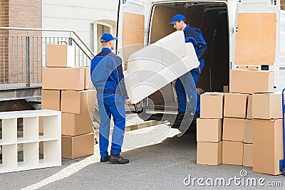 Movers Unloading Sofa From Truck Stock Photo