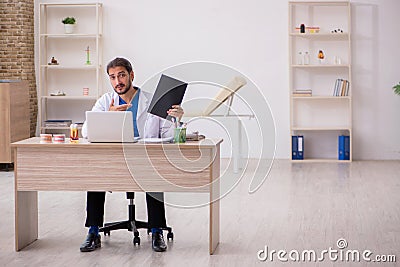 Young male odontologist working in the clinic Stock Photo