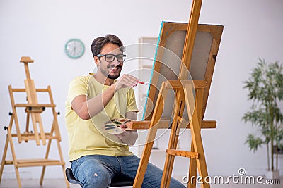 Young man enjoying painting at home Stock Photo