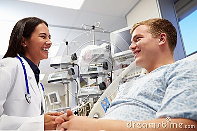 Young Male Patient With Female Doctor In Emergency Room Stock Photo