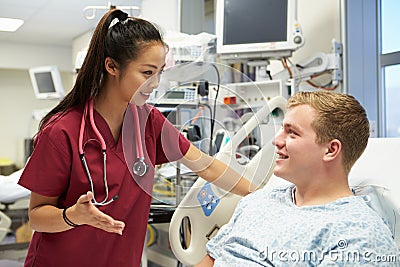 Young Male Patient Talking To Female Nurse In Emergency Room Stock Photo