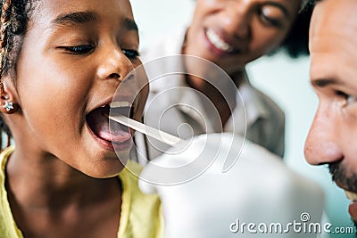 Young male pediatrician doctor examining child at office. Healthcare prevention exam people concept Stock Photo