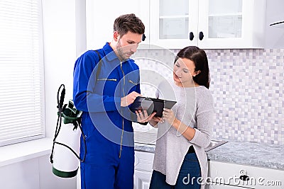 Pest Control Worker Showing Invoice To Woman Stock Photo