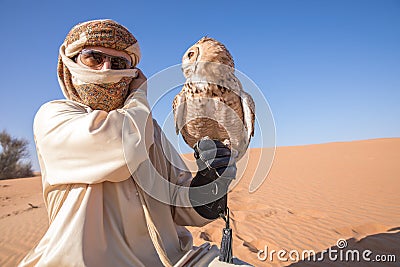 Young male pharaoh eagle owl during a desert falconry show in Dubai, UAE. Stock Photo