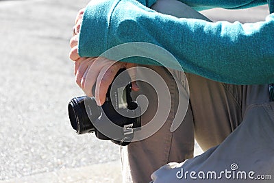 Young male photographer holding his camera on a sunny day Stock Photo