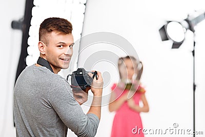 Young male photographer smiles before resuming Stock Photo