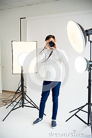 Young male photographer in studio Stock Photo