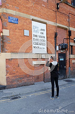 Young Male Photographing famous Mosaic in Manchester Editorial Stock Photo