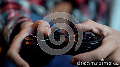 Young male playing computer games holding joystick, addicted person, leisure Stock Photo