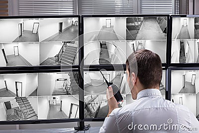 Security Guard Monitoring CCTV Footage Stock Photo