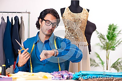 The young male tailor working at workshop Stock Photo