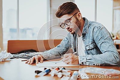 Young Male Talanted Artist Focused on Paining Stock Photo