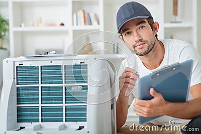 Young male technician checking digital photocopier machine Stock Photo