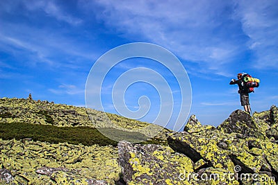 Young male tourist photographs a beautiful mountains with moss covered Stock Photo