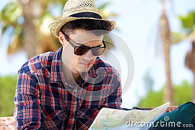 Young male traveler reading map outside Stock Photo