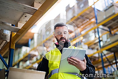 Male warehouse worker with tablet. Stock Photo